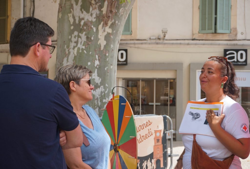 A carvaner engaging with the participants during the Wheel of Foretune activity. 